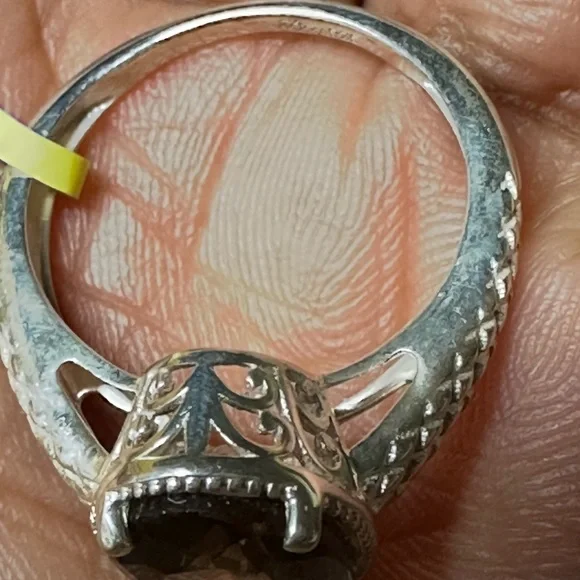 This is a sterling silver ring featuring a smoky quartz gemstone